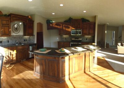 Omaha home builders kitchen with lots of daylight and oak flooring.