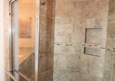 Shower with tile bench seat and recessed shelf.