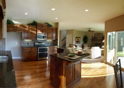 New home kitchen with hardwood floors and patio door.
