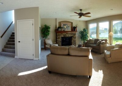 New two story family room with gas fireplace and big windows.