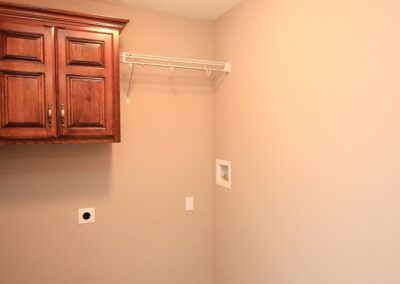 Laundry room with storage cabinet and shelf in Papillion, NE.