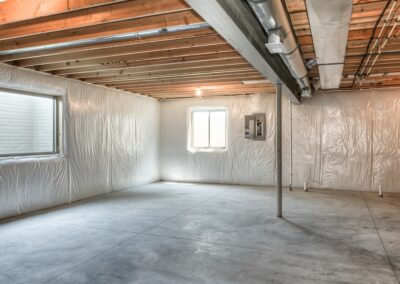 Unfinished basement with bright windows and insulation