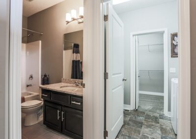 Ranch home bathroom that is connected to laundry room & closet