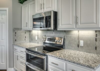 White kitchen cabinets with tile backsplash