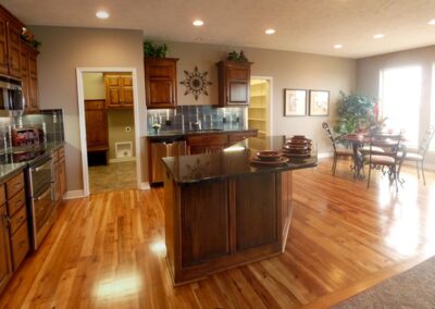 Huge kitchen and dinette with hardwood flooring.