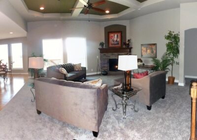 Family room with large windows and gas fireplace.