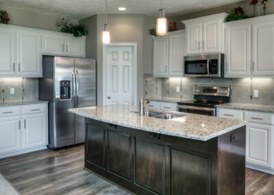 Omaha Home Builders kitchen with island sink painted cabinets.