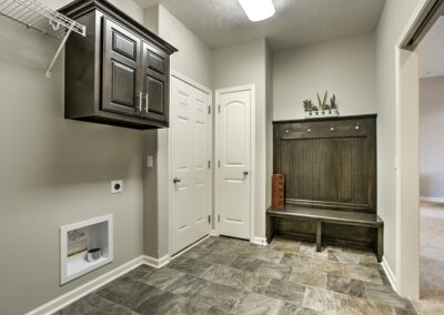 "Mud Room" with birch cabinets that are stained ebony and white woodwork.