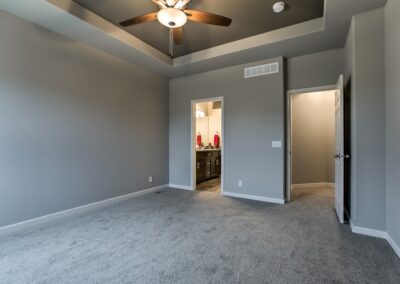 Primary bedroom with raised ceiling and fan in Omaha, NE.