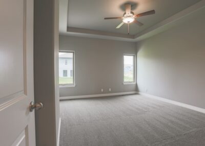 Primary Bedroom w/ high ceiling & 2 day light windows by Aurora Homes