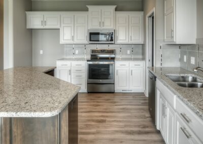 New home kitchen with painted cabinets by Aurora Homes Omaha.