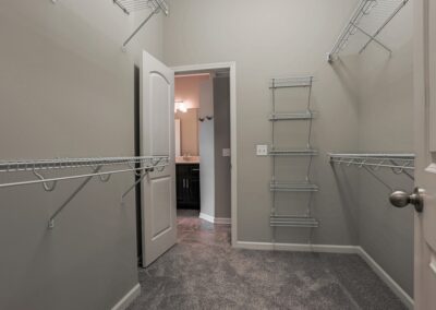 Walk in closet with tall ceiling.