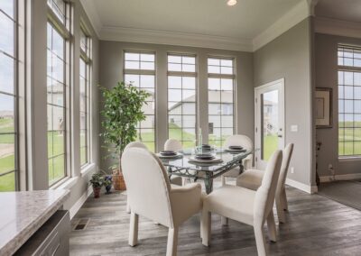 Dinette w/ high ceiling, large windows, & 6 chair glass table