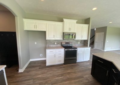 White birch kitchen cabinets and slate appliances by Aurora Homes Omaha