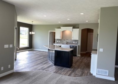 Kitchen with island by Aurora Homes Omaha, NE. Unfurnished new house.