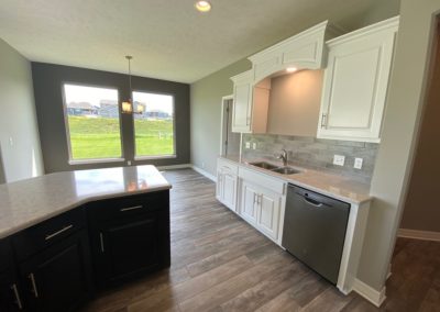 Kitchen and dinette with large windows and green back yard