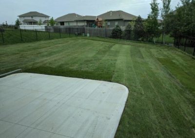 Large fenced back yard with mature landscaping near Omaha, NE.