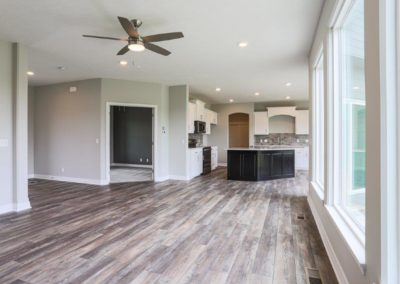 Family room, flex room, and kitchen with hard LV flooring by Aurora Homes