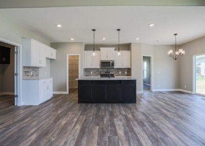 Kitchen and dinette with walk in pantry, center island sink, and modern cabinets.