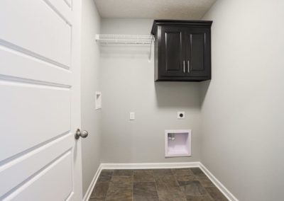 Unfurnished Laundry Room with black cabinet.