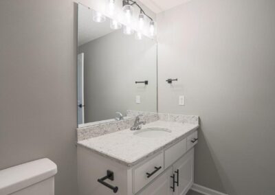 Finished Basement Vanity with black and white accessories.