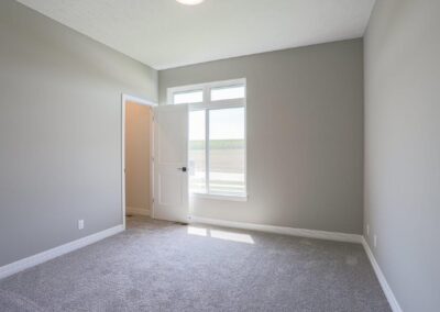 New home bedroom with large window and walk in closet