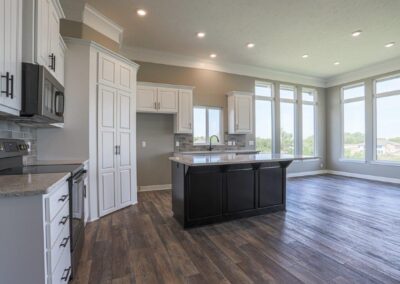 Kitchen with high ceilings, huge windows, and hidden pantry in Papillion, NE.