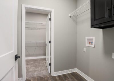 Laundry room that is adjacent to the primary bedroom walk-in closet.