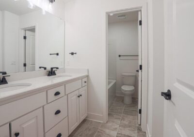 modern bathroom with 2 sinks by Aurora Homes in Omaha