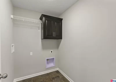 laundry room with cabinet and shelf